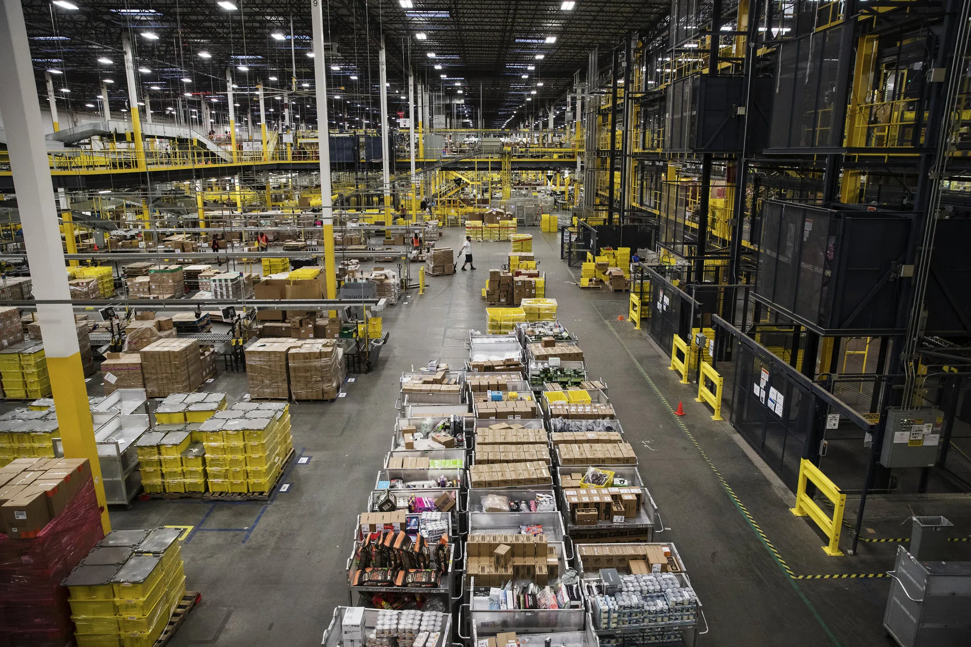 An employee moves a pallet of boxes at an Amazon.com Inc. fulfillment center.