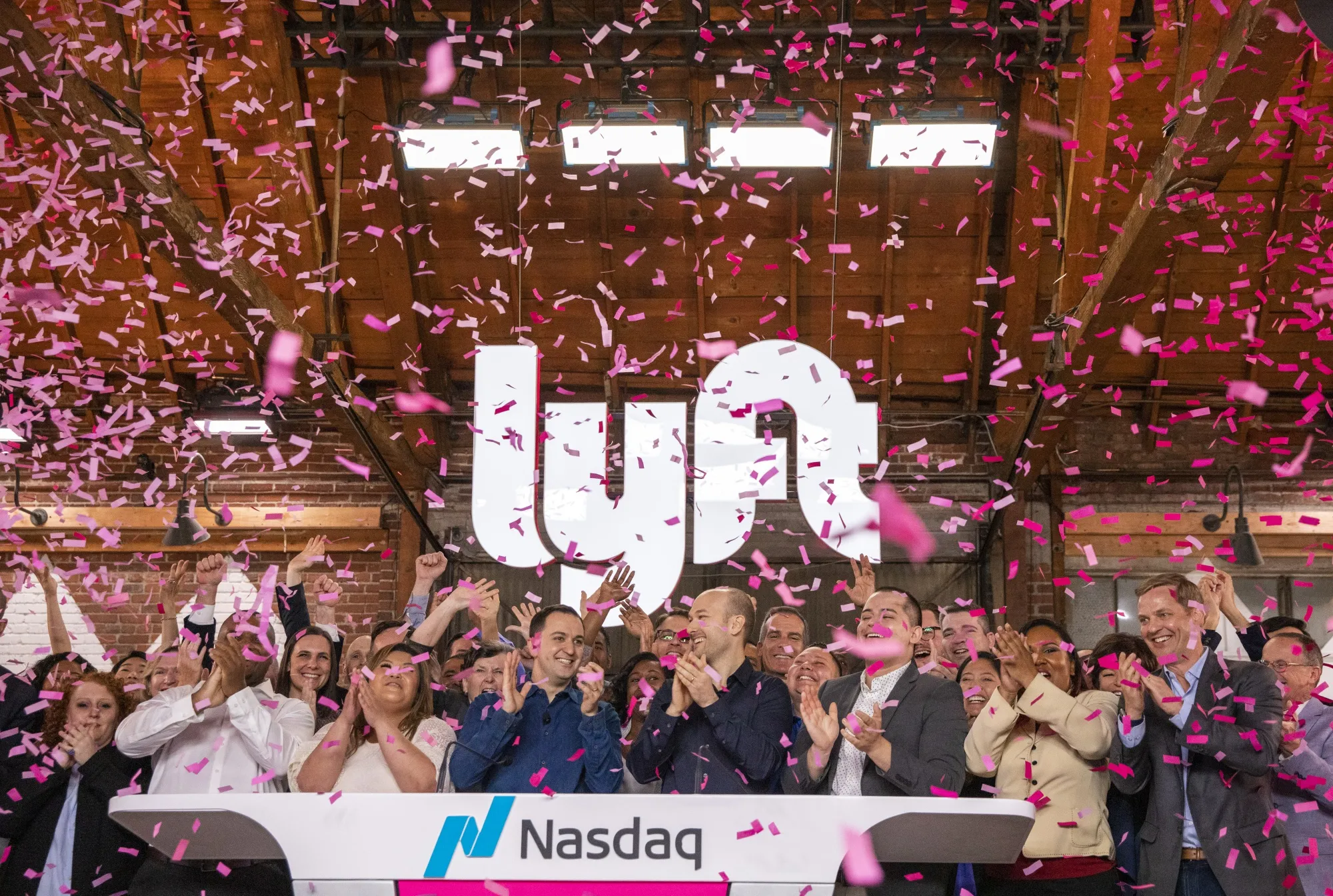 Confetti falls as John Zimmer, center left, and Logan Green, center right, ring the opening bell during the company's IPO&nbsp;in Los Angeles, on&nbsp;March 29.&nbsp;