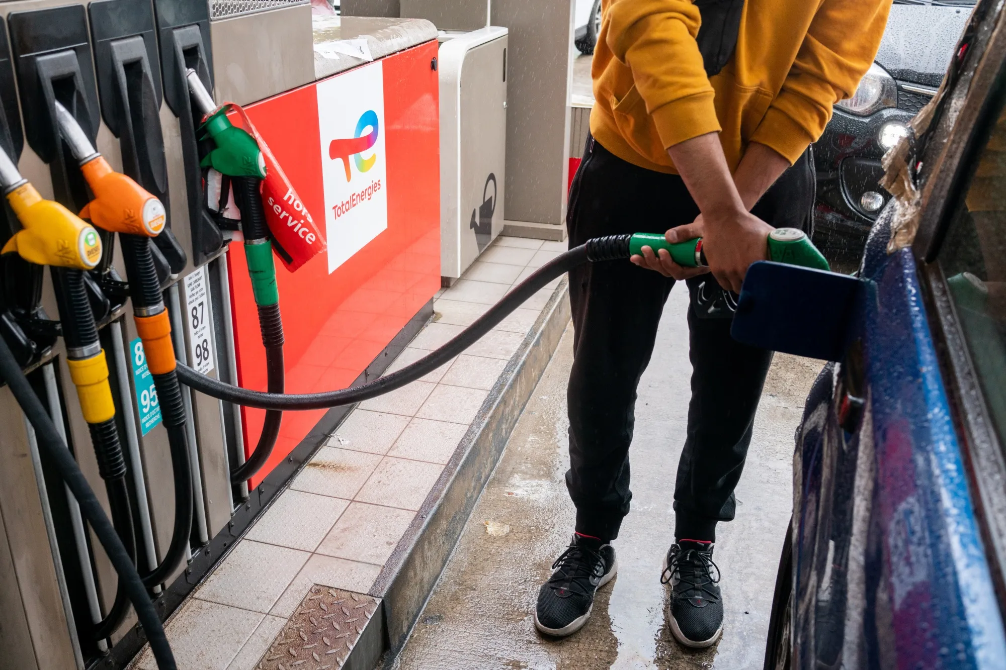 A customer refuels his vehicle at a gas station in Paris.