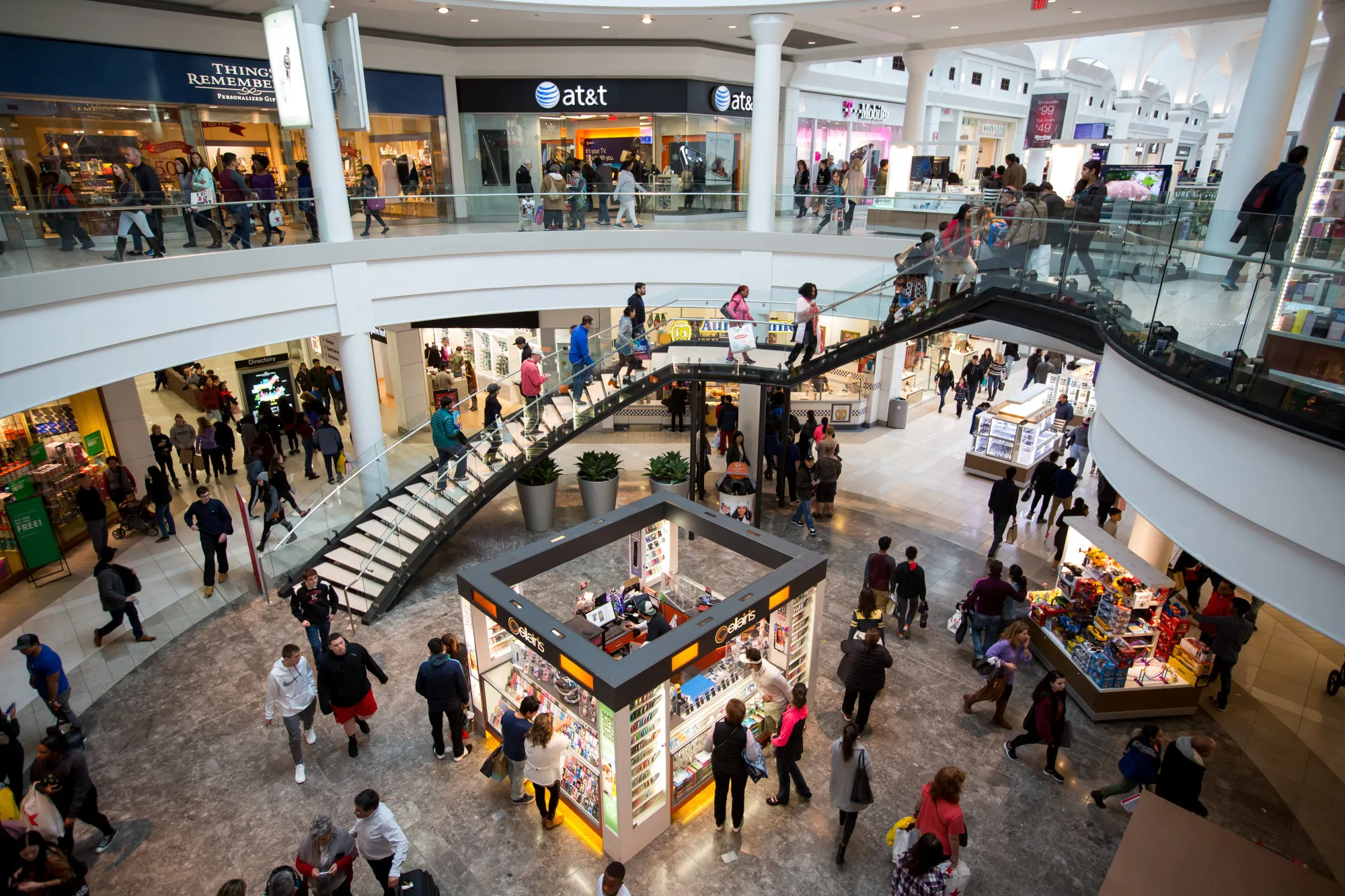 Shoppers walk through the Menlo Park Mall in Edison, New Jersey, U.S., on Friday, Nov. 25, 2016. As Black Friday ushers in the year-end shopping rush, chains are touting larger price cuts than in 2015 -- a gamble that maintaining market share is worth squeezing margins.