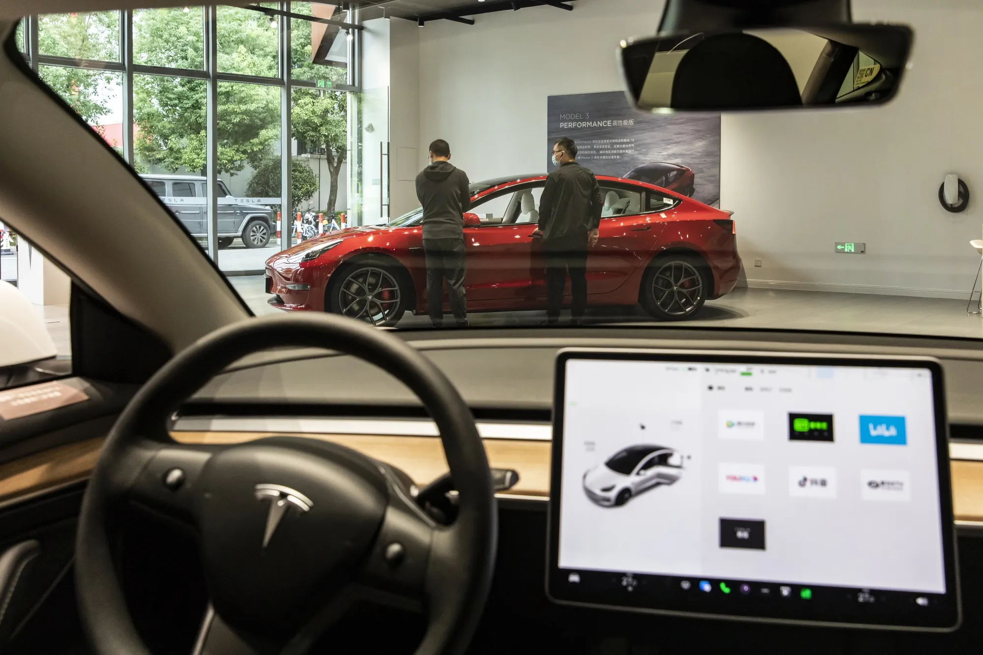 Customers at a Tesla Inc. showroom in Shanghai.
