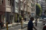 Residents pass through Huanggang village in Shenzhen, China, on Monday, Oct. 11, 2021. 