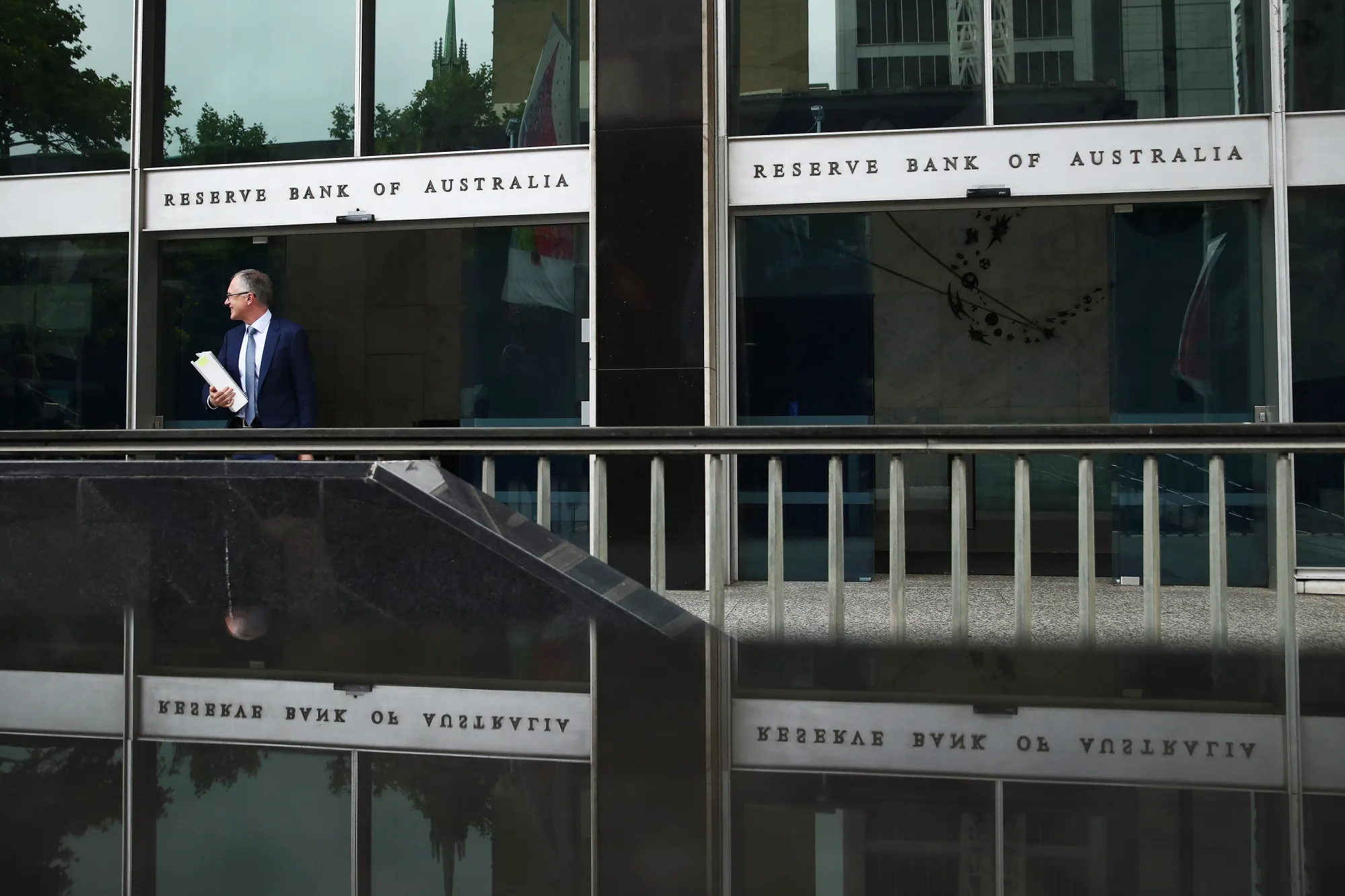 A man exits the Reserve Bank of Australia headquarters in Sydney, Australia.