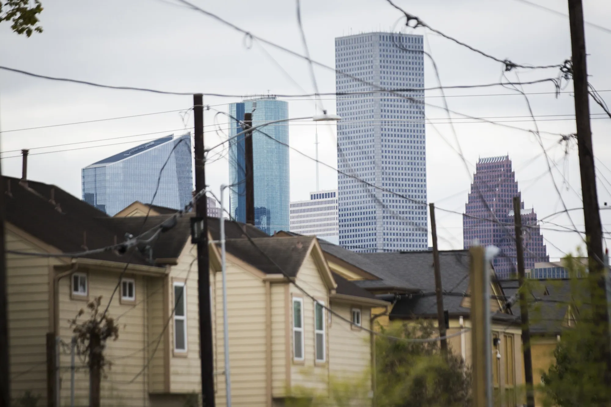 The skyline of downtown Houston looms over homes in the Fifth Ward neighborhood in 2018.&nbsp;