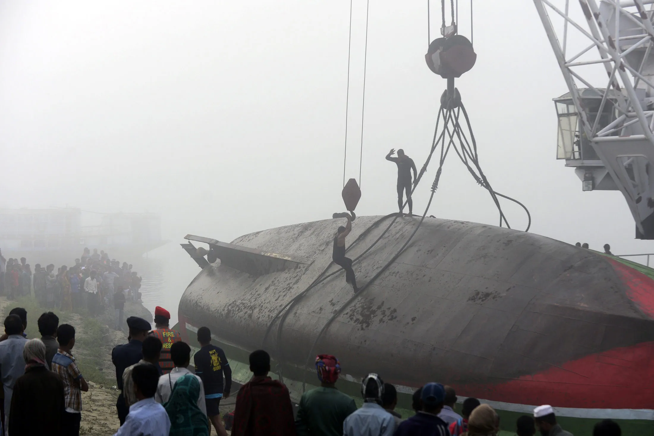 rescue services attempt to move the capsized ferry at Paturia some 70 kms east of Dhaka, Bangladesh, on Feb. 23, 2015.
