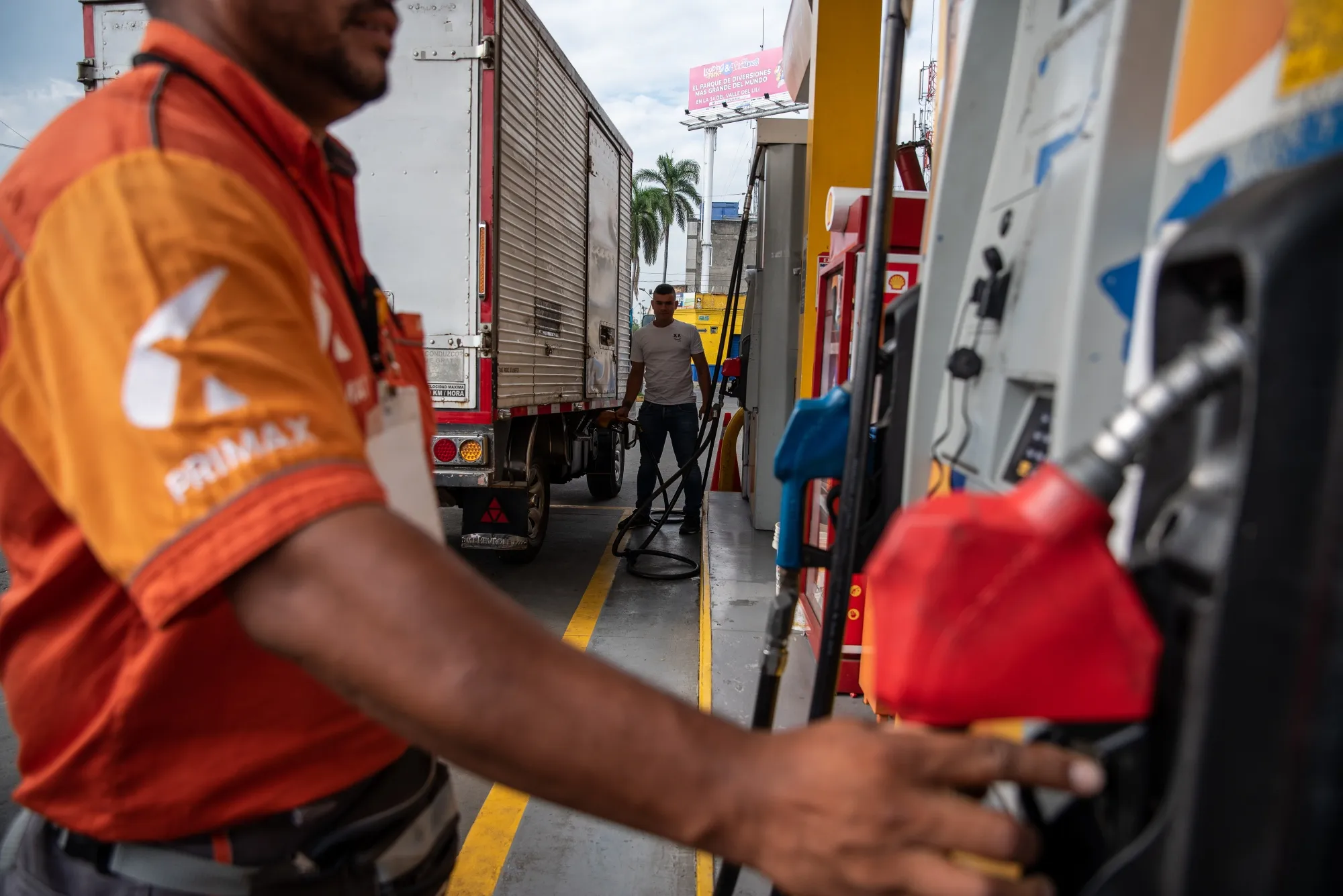 Attendants at a gas station in Cali, Colombia.
