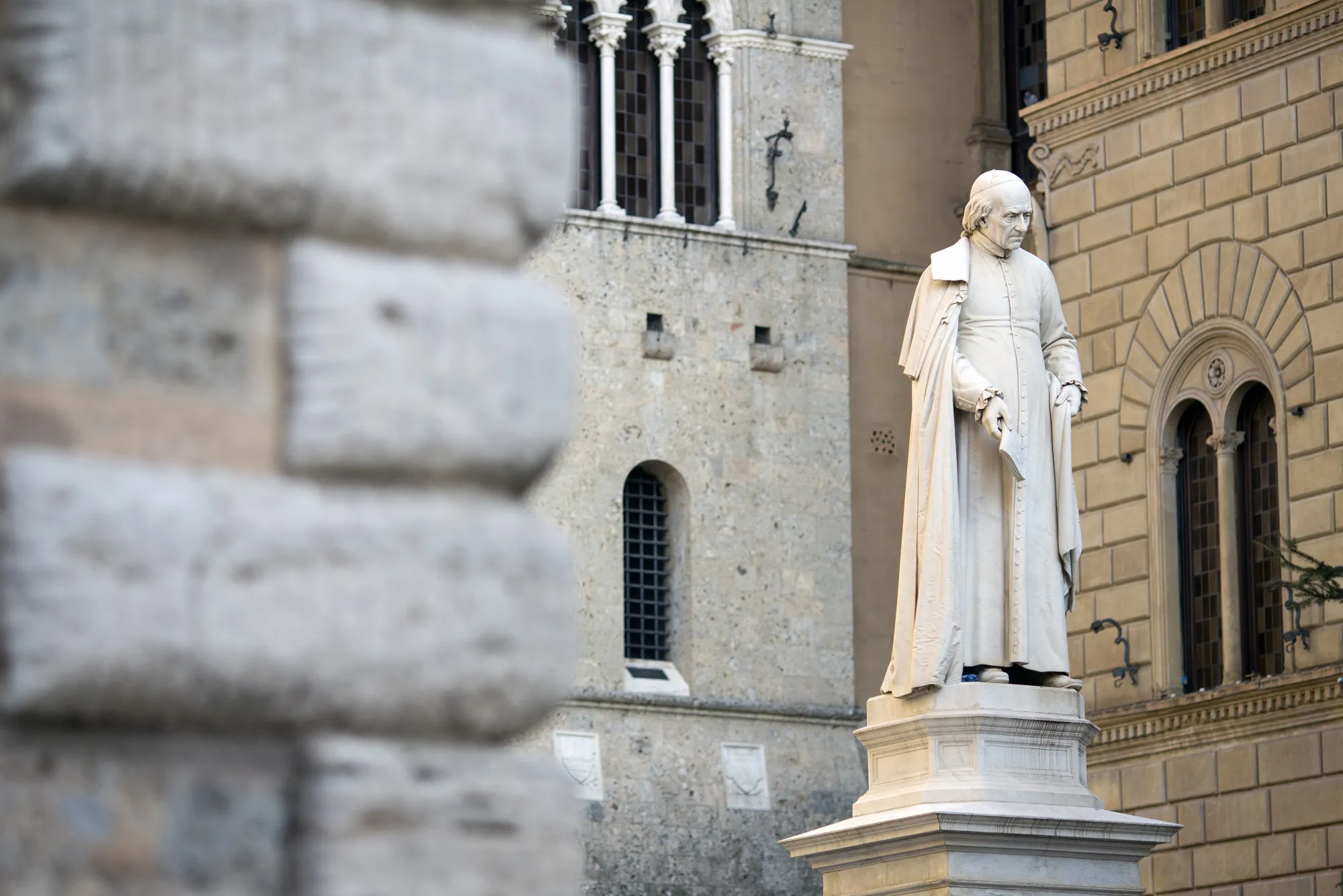 The statue of Sallustio Bandini, an economist and politician, stands in Piazza Salimbeni in front of the Monte dei Paschi di Siena SpA bank headquarters in Siena.