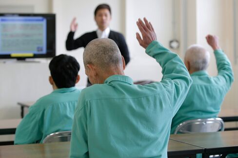 Inmates listen to a lecture by Takeshi Izumaru, director at the Nagasaki Community Support Center at Sasebo Prison in Sasebo, Nagasaki Prefecture, Japan.