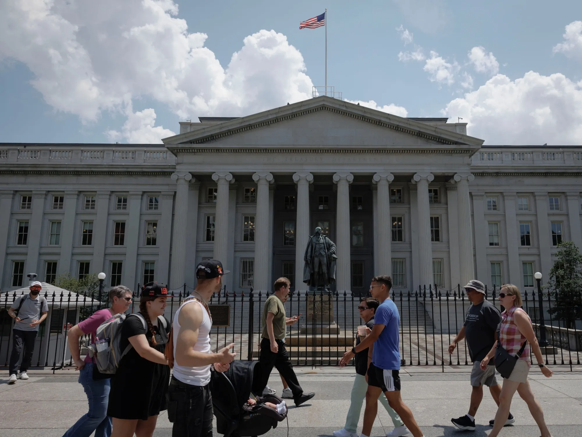Pedestrians walk past the US Treasury building in Washington.