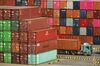 A truck stands next to shipping containers stacked at the Yangshan Deepwater Port, operated by Shanghai International Port Group Co. (SIPG), in Shanghai, China, on Friday, May 10, 2019. The U.S. hiked tariffs on more than $200 billion in goods from China on Friday in the most dramatic step yet of President Donald Trump's push to extract trade concessions, deepening a conflict that has roiled financial markets and cast a shadow over the global economy.