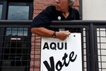 A Bexar County employee sets up signs during early voting at a polling location in San Antonio, Texas on Oct. 22, 2018.