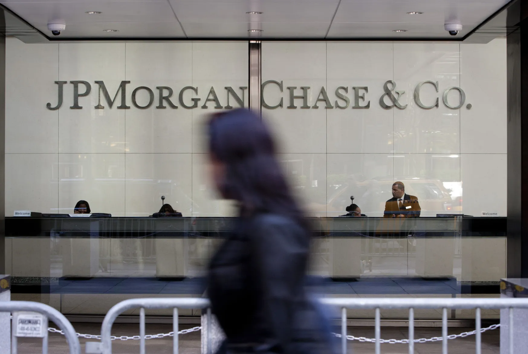 Pedestrians walk past JPMorgan Chase &amp; Co. headquarters in New York.