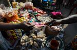 A customer pays for food at a market in Accra, Ghana.