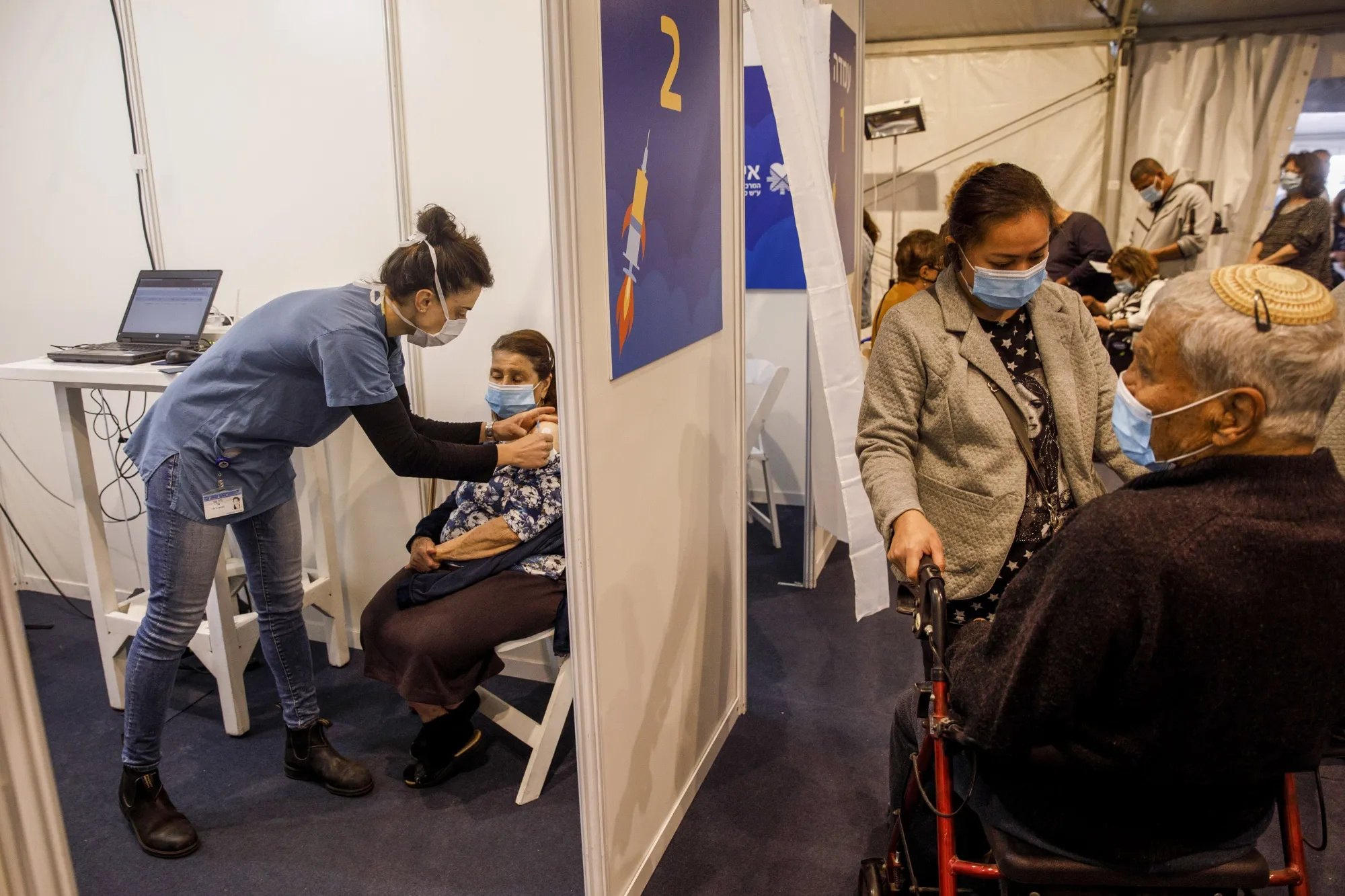 A nurse administers a dose of the Pfizer-BioNTech Covid-19 vaccine at Rabin Square in Tel Aviv.