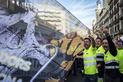 Striking port workers march through Barcelona on Tuesday