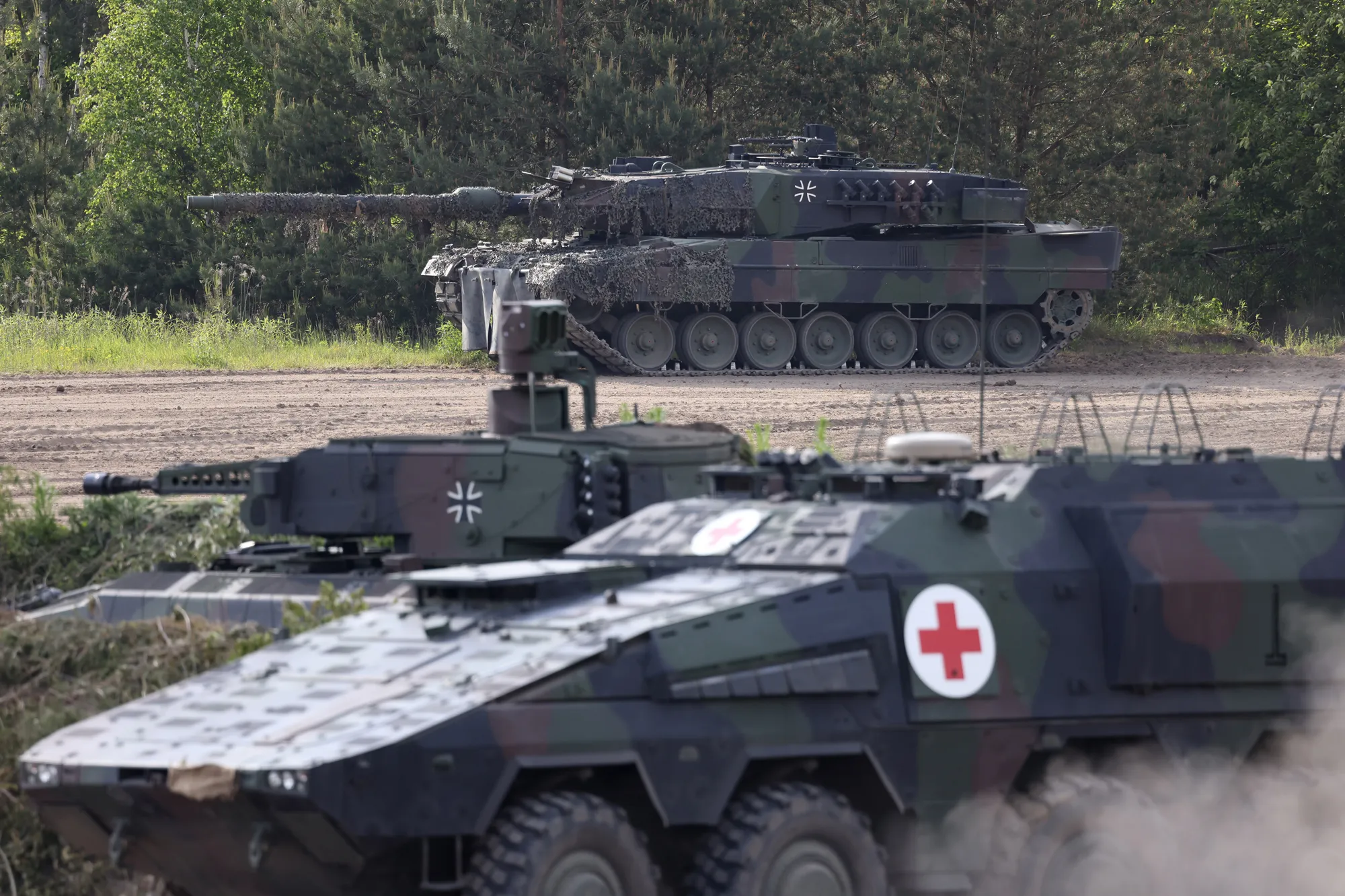A Bundeswehr Leopard 2 heavy tank, top,&nbsp;Puma combat vehicle, and Boxer medical transporter.