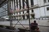 A person sits on a bench outside the New York Stock Exchange (NYSE) in New York, U.S., on Wednesday, June 24, 2020. New York, New Jersey and Connecticut will require visitors from virus hot spots to quarantine for 14 days.