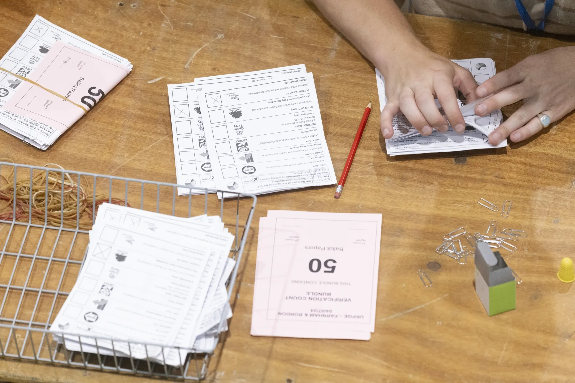 An official counts ballots following the UK general election.
