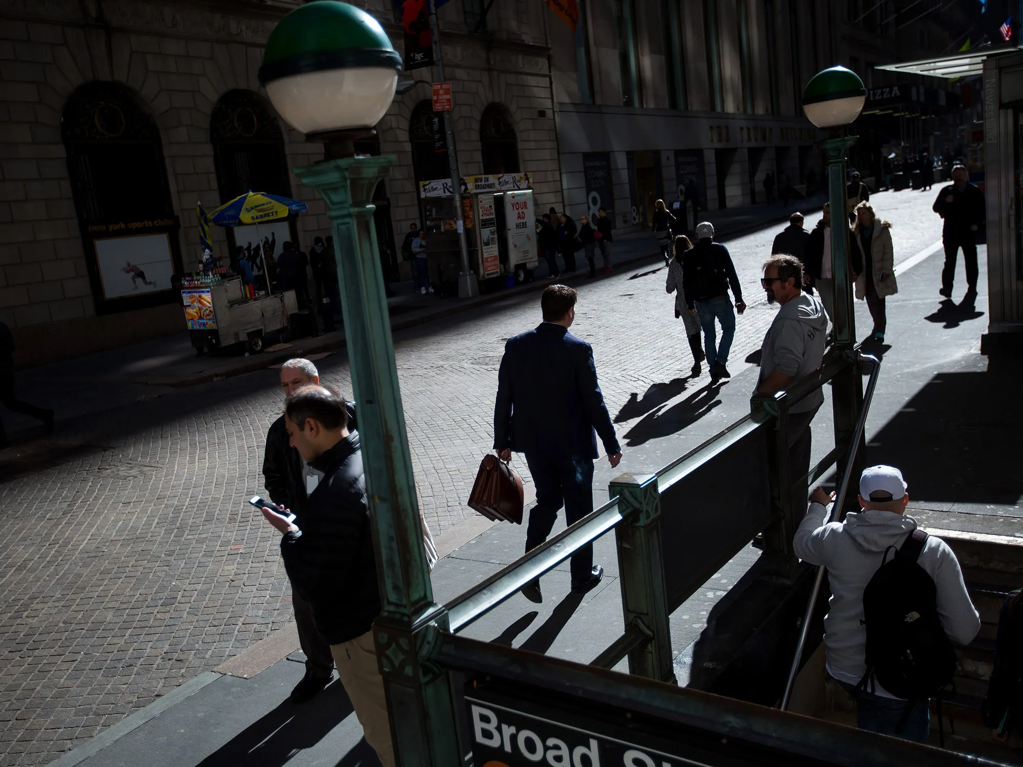 Pedestrians walk along Wall Street near the New York Stock Exchange.