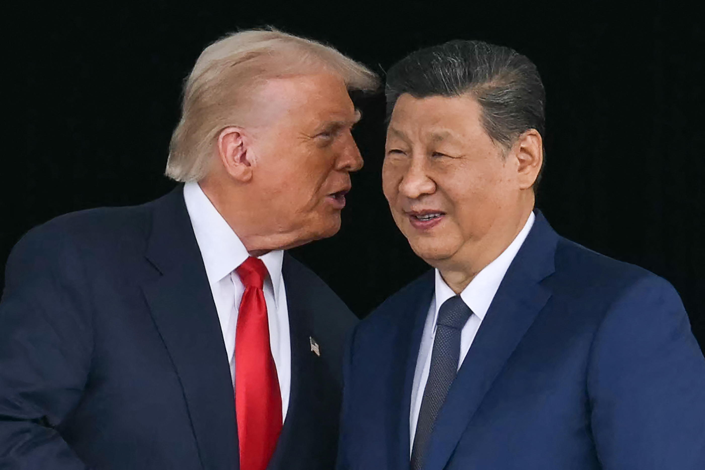 TOPSHOT - US President Donald Trump (L) talks to China's President Xi Jinping as they shake hands after their talks at the Gimhae Air Base, located next to the Gimhae International Airport in Busan on October 30, 2025. US President Donald Trump and China's leader Xi Jinping opened on October 30 their first face-to-face meeting in six years, seeking a truce to end a trade war that has roiled the world economy. (Photo by ANDREW CABALLERO-REYNOLDS / AFP) (Photo by ANDREW CABALLERO-REYNOLDS/AFP via Getty Images) Photographer: ANDREW CABALLERO-REYNOLDS/AFP