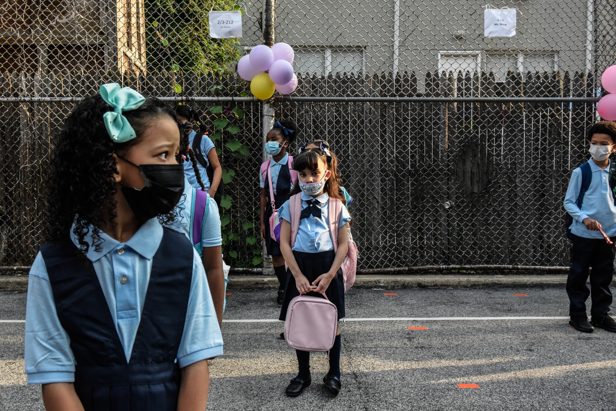 Students wait in line to enter a public school on the first classes in the Bronx borough in New York.