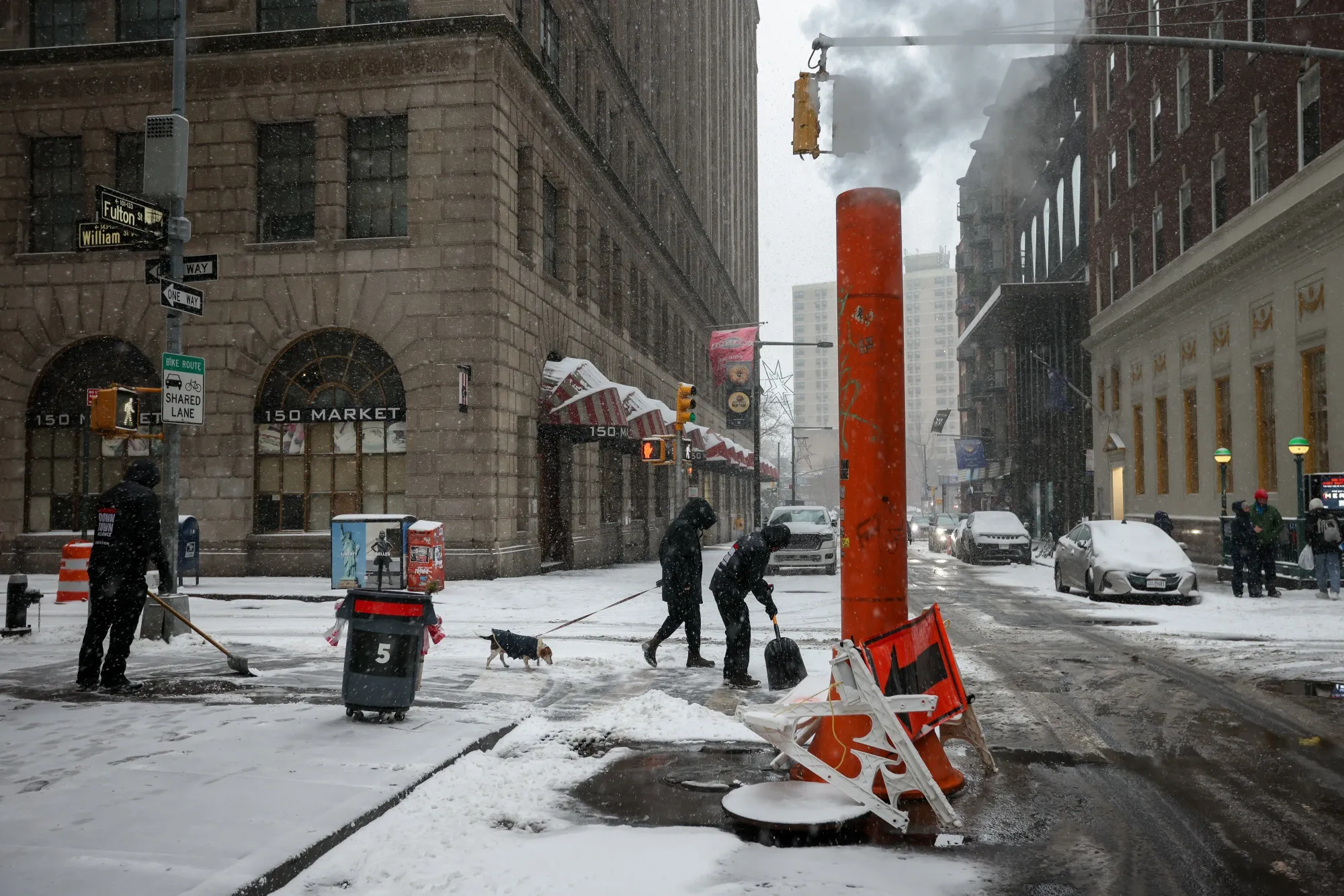 Workers clear snow during a winter storm in Lower Manhattan in New York on Jan. 25.
