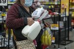A shopper holds groceries while waiting to checkout inside a grocery store in San Francisco.