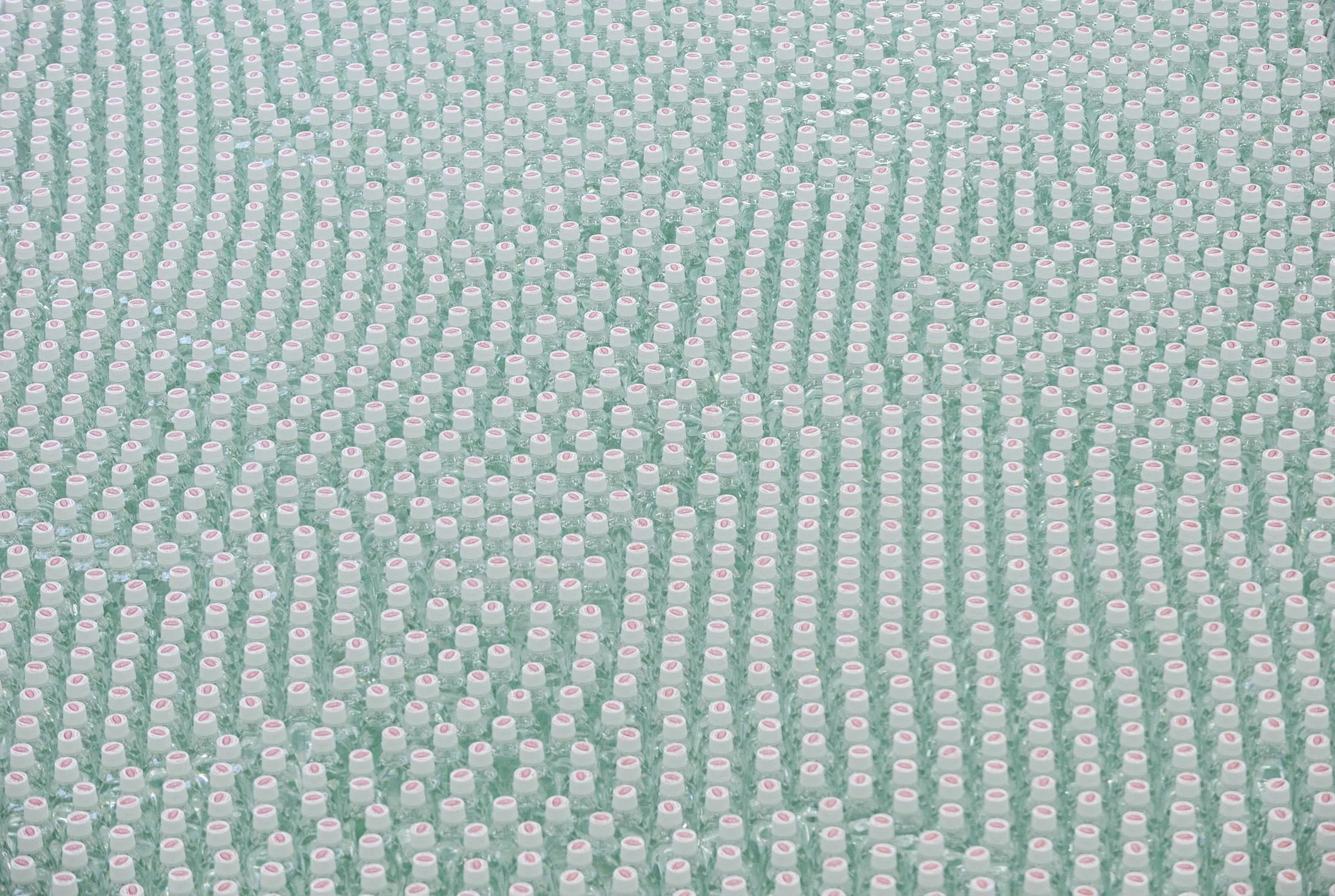 Bottles of Wilkinson sparkling water move along the production line of the Asahi Soft Drinks Co. Mount Fuji factory in Fujinomiya, Shizuoka Prefecture, Japan, on Wednesday, March 19, 2014. Asahi Soft Drinks Co. is a unit of Asahi Group Holdings Ltd., Japan's second-largest beermaker.
