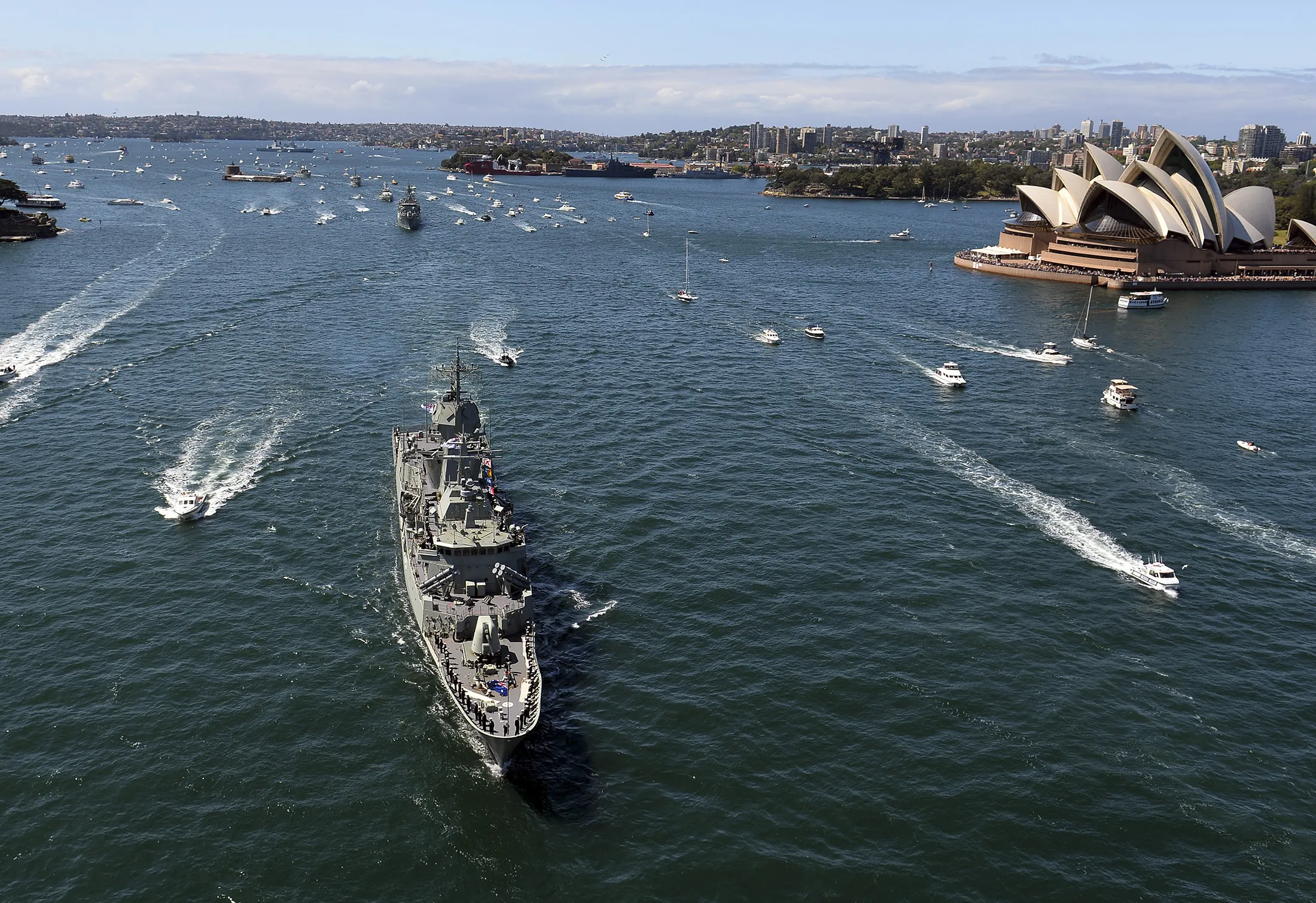 Royal Australian Navy warship HMAS Paramatta sails in front of the iconic Sydney Opera House on October 4, 2013 as part of celebrations to commemorate 100 years since the Royal Australian Navy's fleet first entered the city's waters. Ships from nations including China, Thailand, the United States, Malaysia, France, Japan and former colonial power Britain passed through the heads into the famous harbour where they joined 16 tall ships from around the world in preparation for a ceremonial fleet review. AFP PHOTO / Saeed Khan (Photo credit should read SAEED KHAN/AFP via Getty Images)
