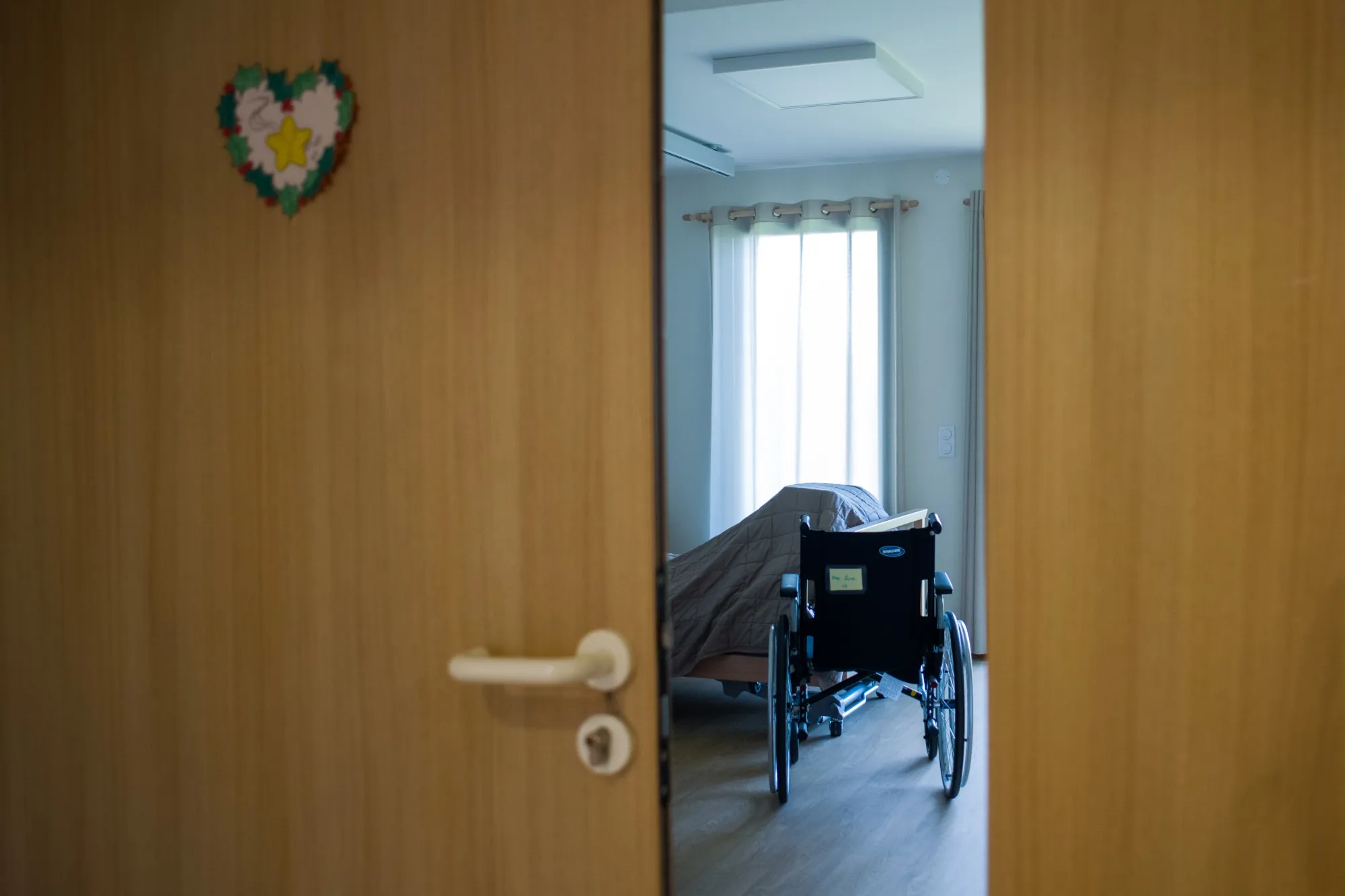 A wheelchair inside the bedroom of a house.