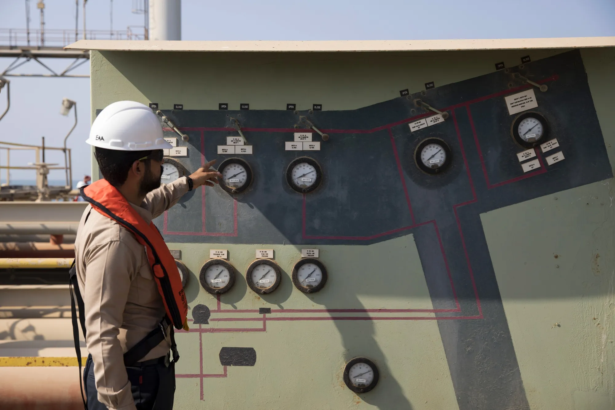 An employee inspects pipeline pressure gauges at the North Pier terminal in Saudi Aramco's Ras Tanura oil refinery.