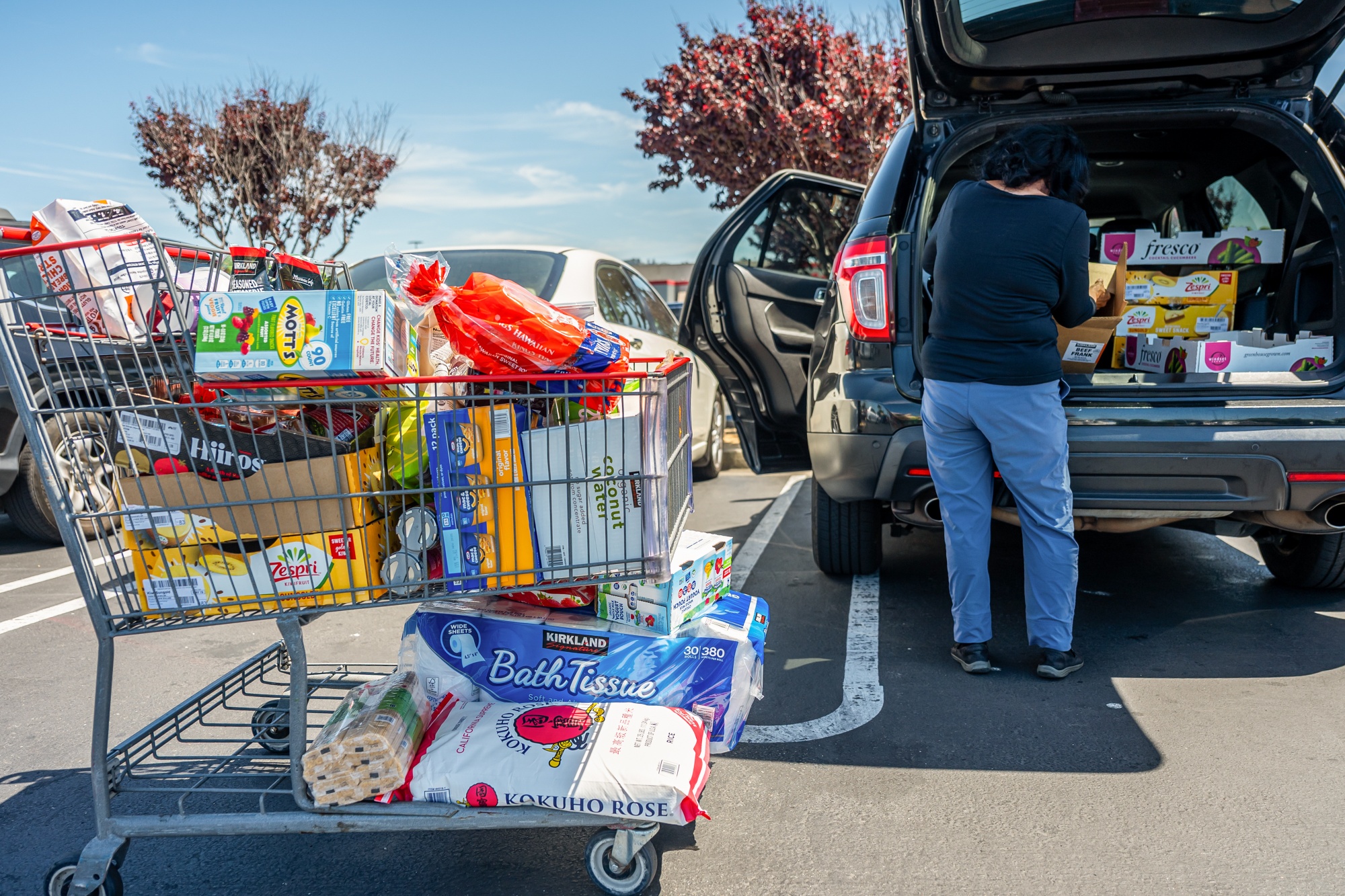 A customer loads items into a car at a Costco store in Richmond, California.