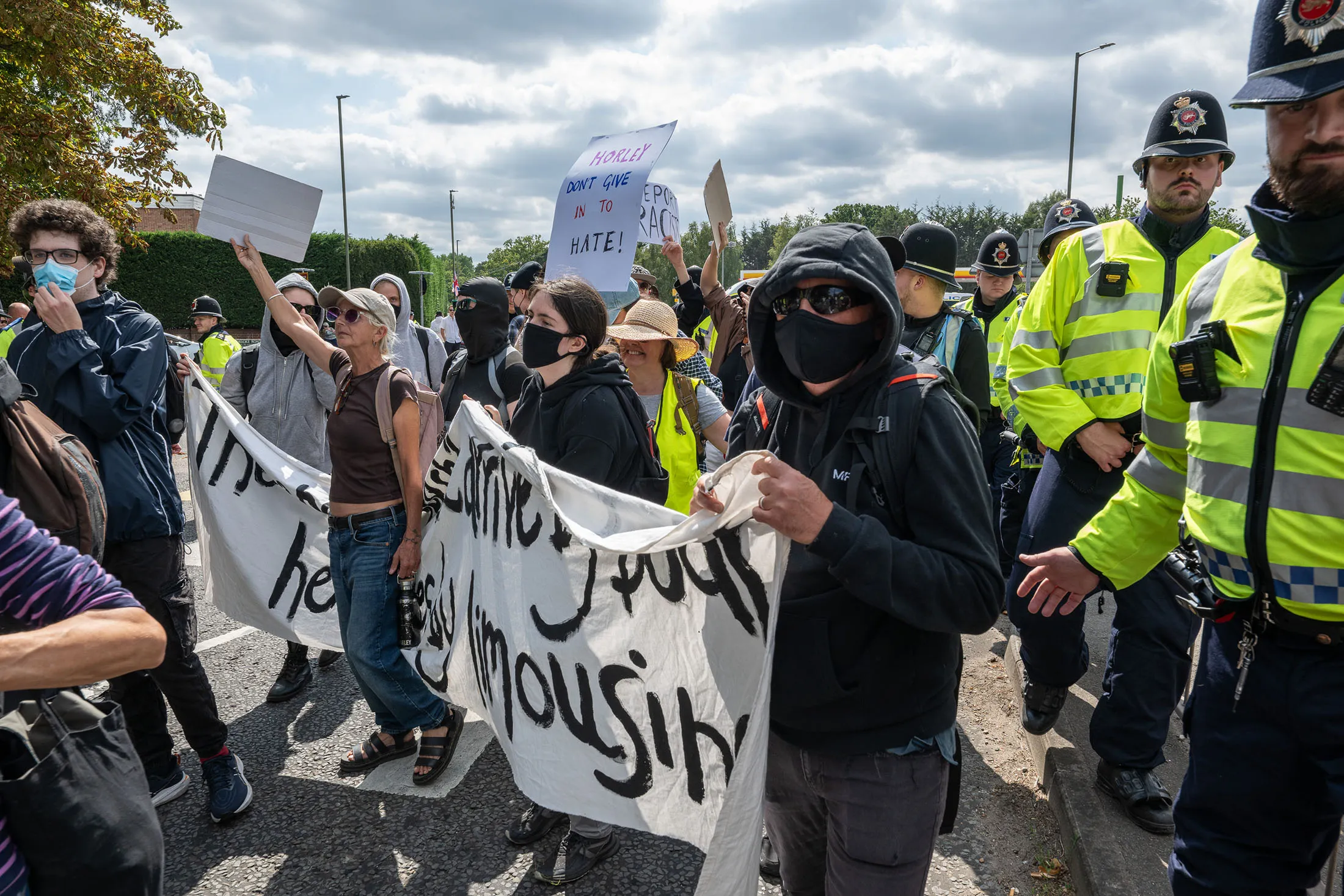 A large police presence keeps anti-migrant protestors and anti-racism protesters apart in Horley, UK,&nbsp;on Aug.&nbsp;23, 2025.