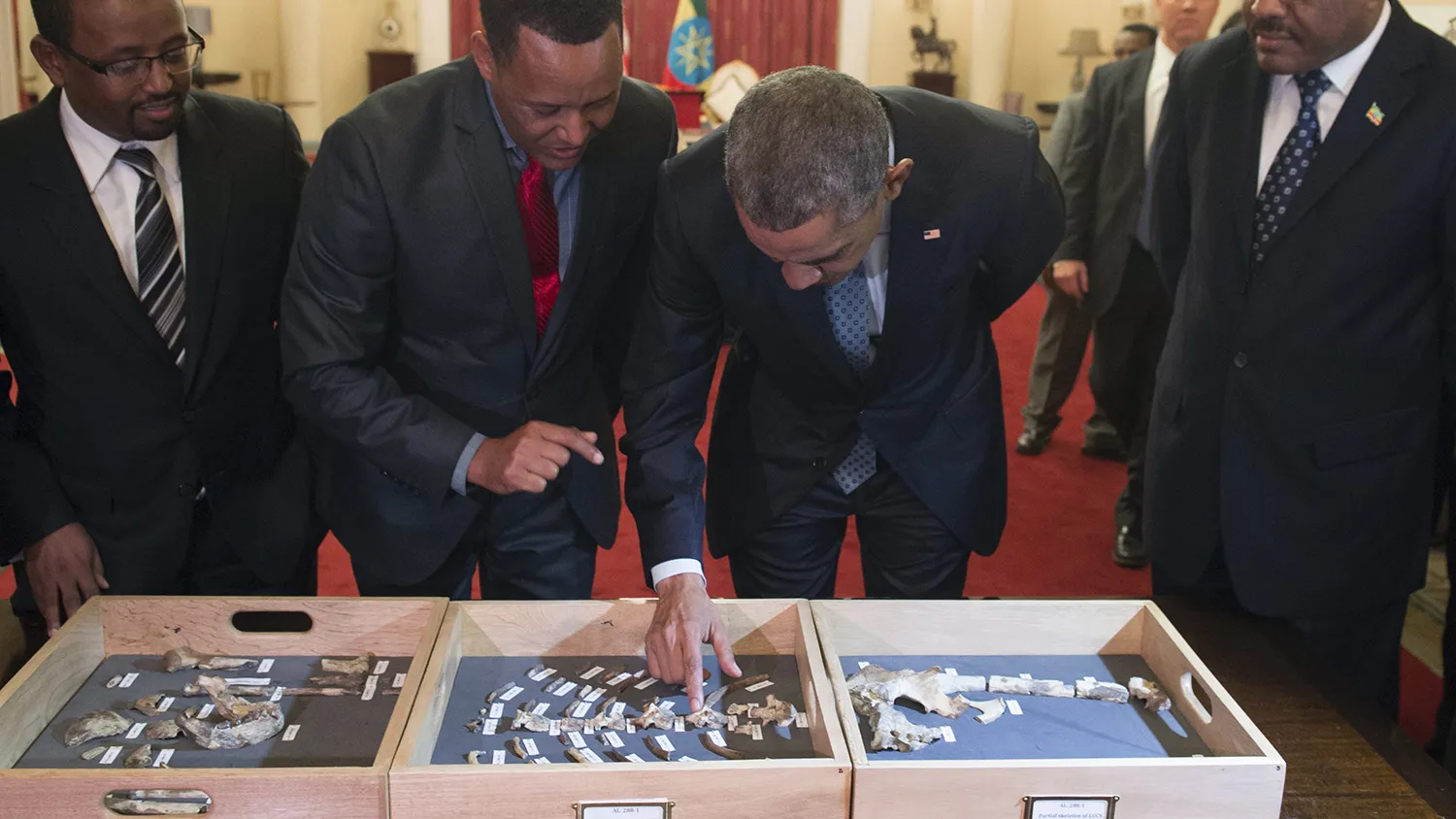 Obama touches a bone fragment of “Lucy,” who was estimated to have lived 3.2 million years ago, alongside Ethiopian Prime Minister Hailemariam Desalegn (right) and Zeresenay Alemseged (second left), head of the California Academy of Sciences, prior to a State Dinner at the National Palace in Addis Ababa on July 27.
