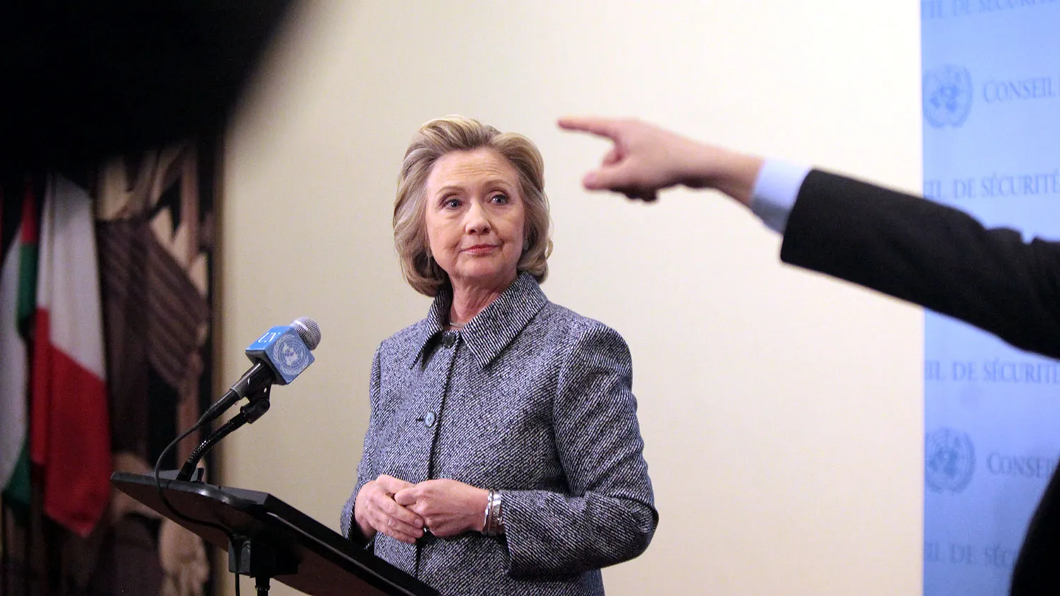 An aide to Former U.S. Secretary of State Hillary Clinton points to a journalist during a question-and-answer session after keynoting a Women's Empowerment Event at the United Nations March 10, 2015 in New York City.
