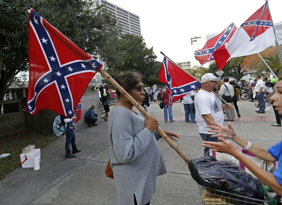 Arlene Barnum, of Oklahoma, with Confederate Veterans' Lives Matter, holds a Confederate flag in front of City Hall in New Orleans, on Thursday, Dec. 10, 2015. 