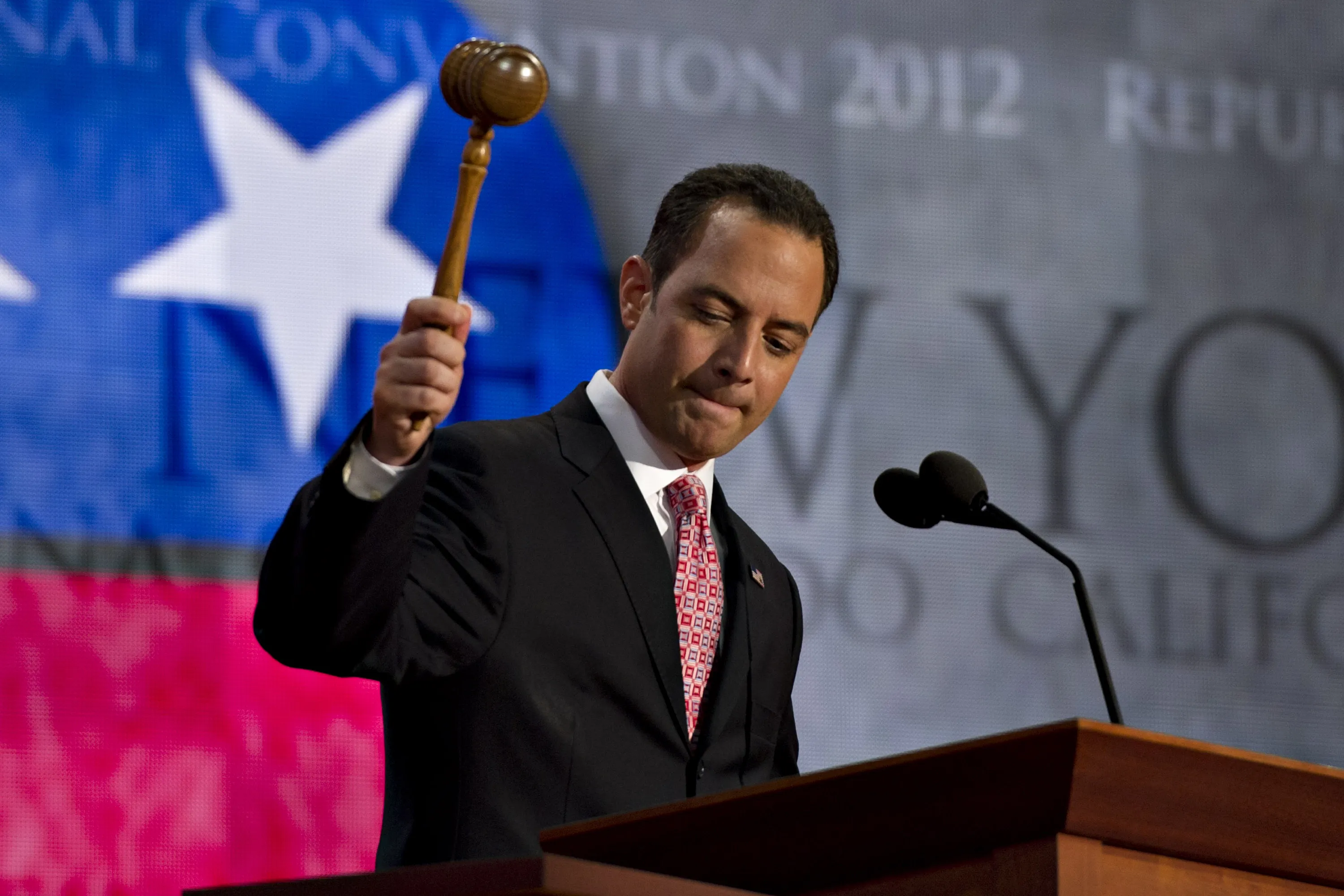 Reince Priebus, chairman of the Republican National Committee, raises a gavel as he calls the Republican National Convention (RNC) to order in Tampa, Florida on Aug. 27, 2012.
