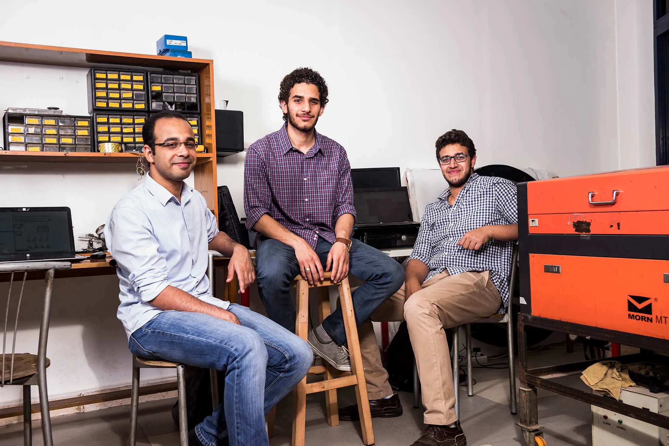 Abuelhagag (left), Elsafty (center), and Nabil take a break in Fab Lab Egypt, without mysterious inspectors.
