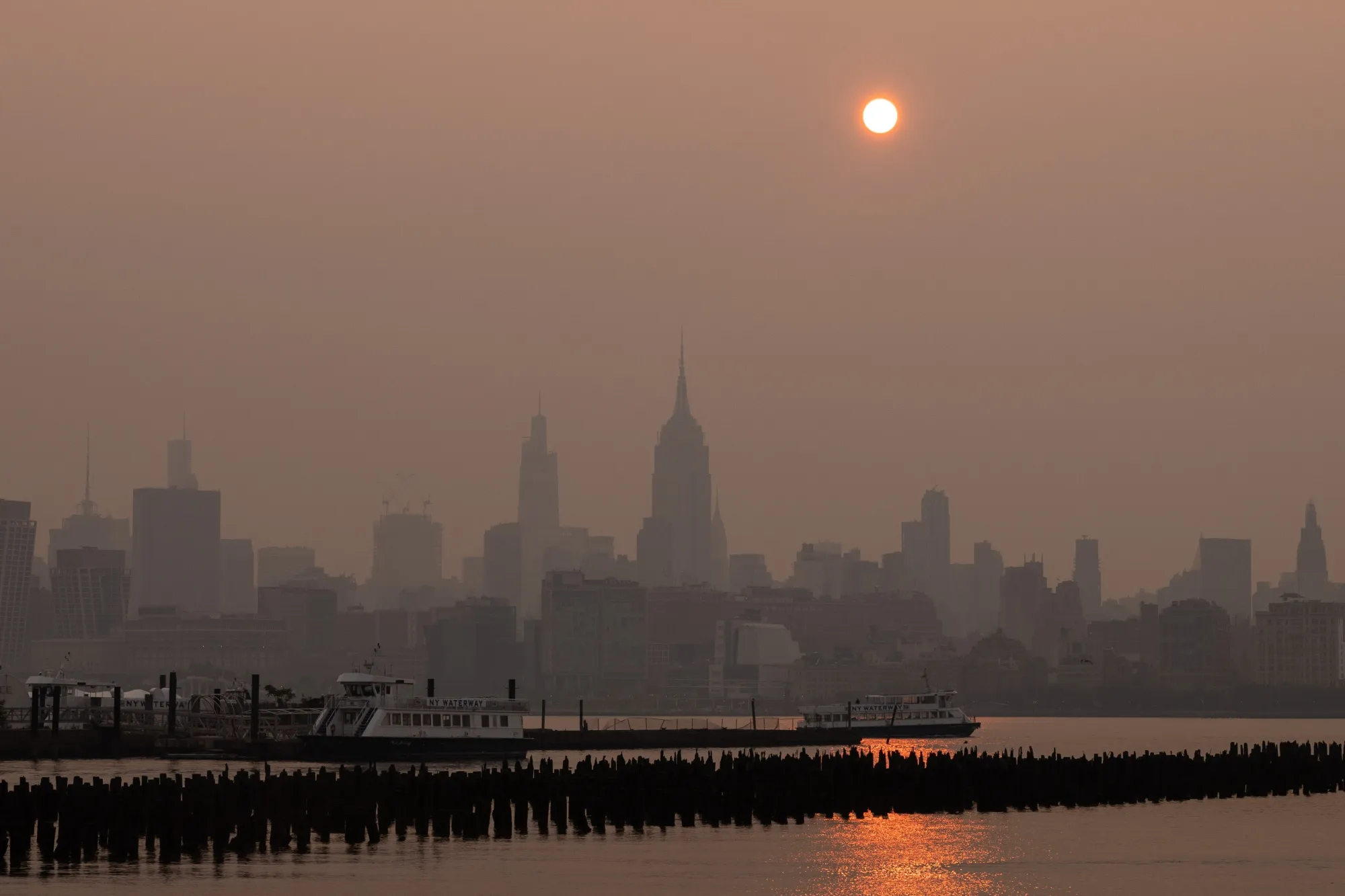 Buildings in the Manhattan skyline shrouded in smoke from Canada wildfires at sunrise on Wednesday.
