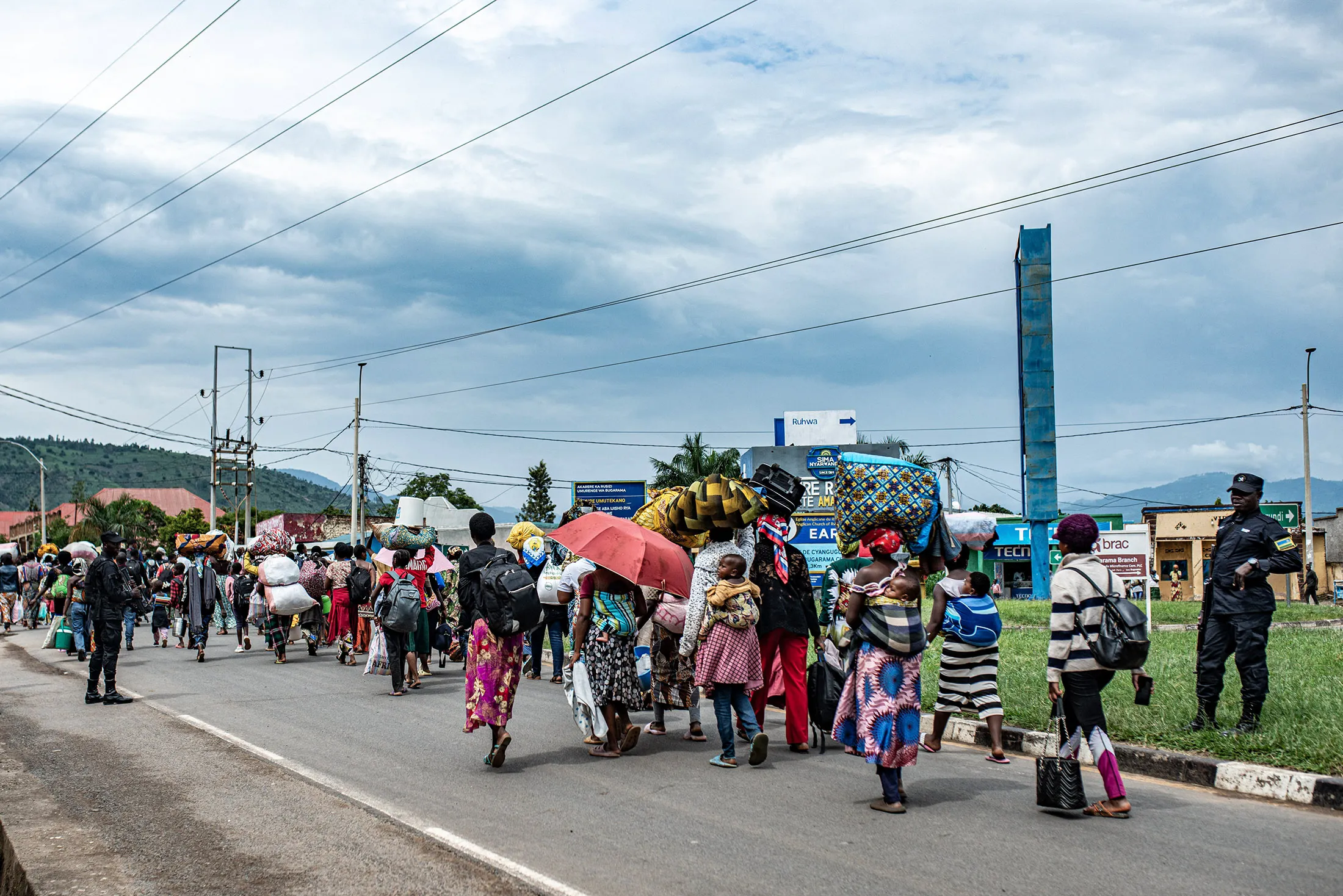 Members of the Rwandan security forces accompany a group displaced people from the Democratic Republic of Congo, in Bugarama, Rwanda, on Dec.&nbsp;5.