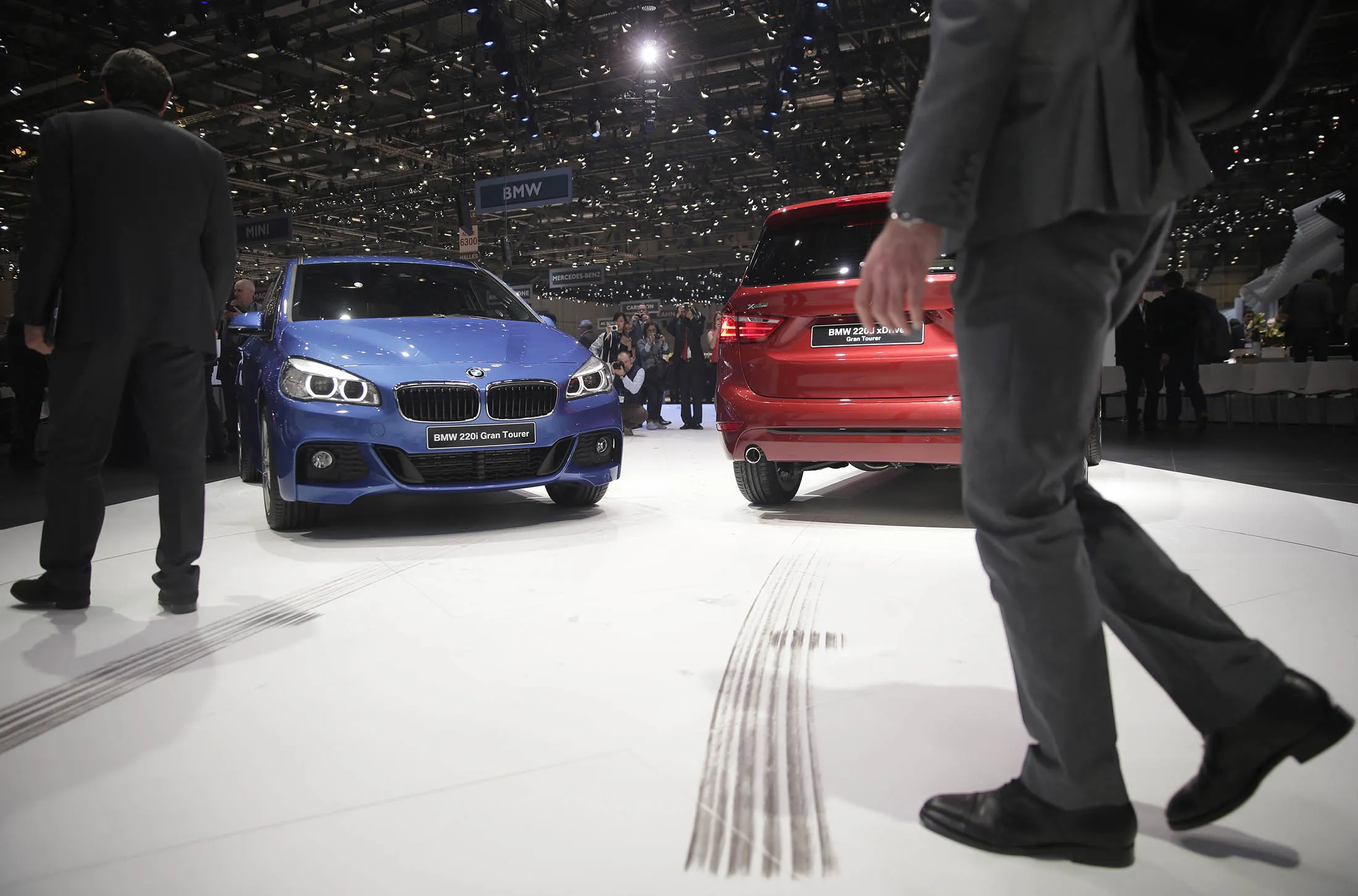 A BMW 220i Gran Tourer automobile, left, and a BMW 220d xDrive Gran Tourer automobile, produced by Bayerische Motoren Werke AG (BMW), stand on display on the opening day of the 85th Geneva International Motor Show in Geneva, Switzerland, on Tuesday, March 3, 2015. The International Geneva Motor Show opens to the public on March 5, and will showcase the latest models from the world's top automakers.
