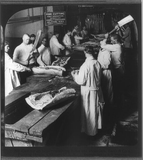 Swift & Co.’s Packing House: cutting up hogs, removing hams and shoulders, circa 1905, Chicago