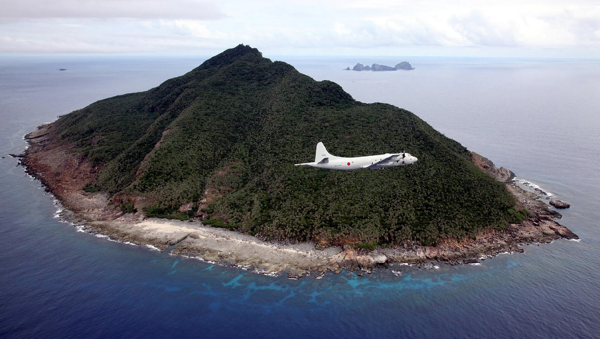 A Japanese patrol plane flies over the islets known as the Senkaku in Japan and Diaoyu in China, Oct. 2011.