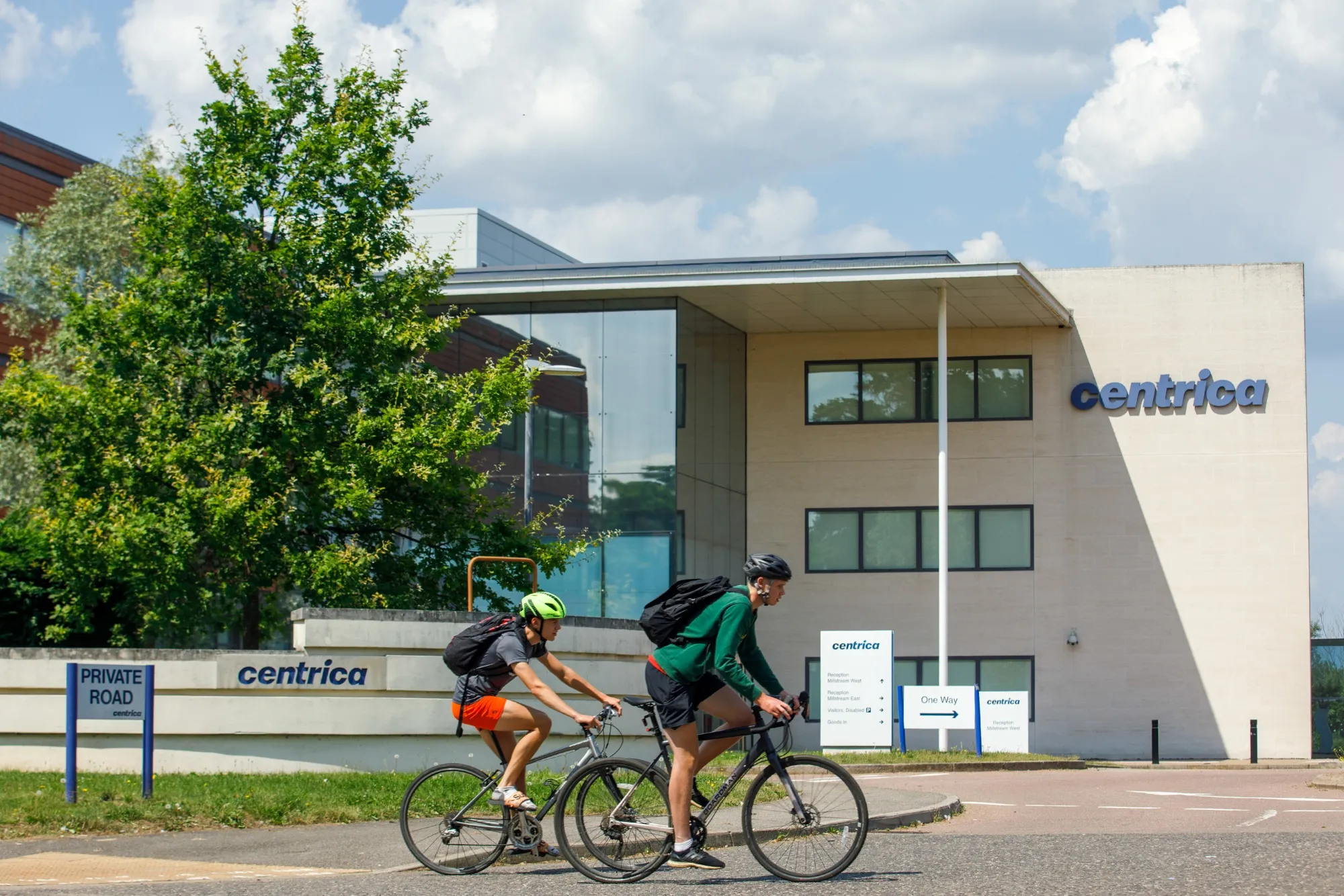 Cyclists pass the headquarters of Centrica Plc at Windsor, U.K.