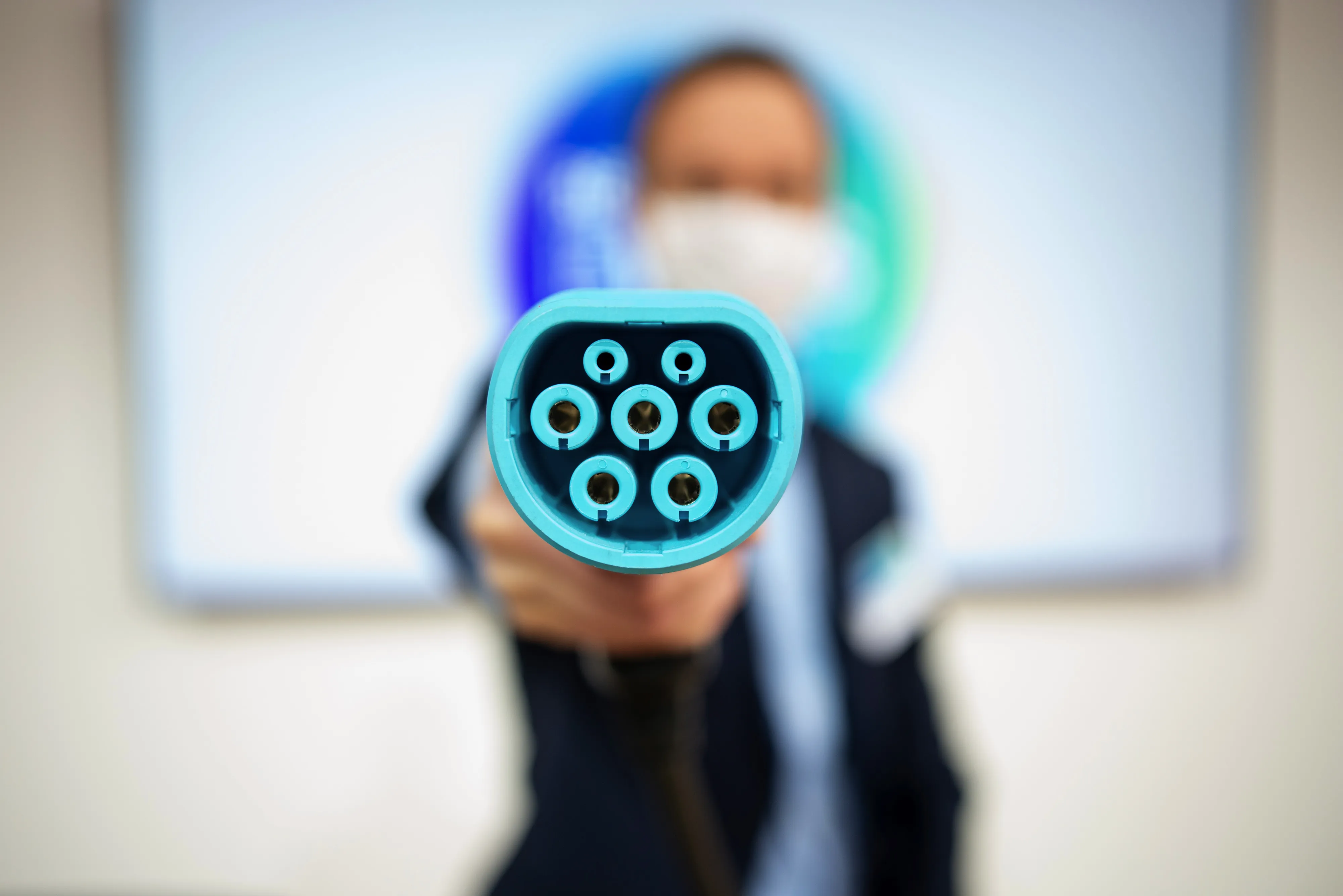 An employee holds an electric charging plug at the Renault E-Ways electric automobile event in Paris in October 2020.