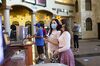 People wearing protective masks stand at a concessions counter at a Regal Cinemas theater in Austin, Texas, U.S., on Friday, Aug. 21, 2020.