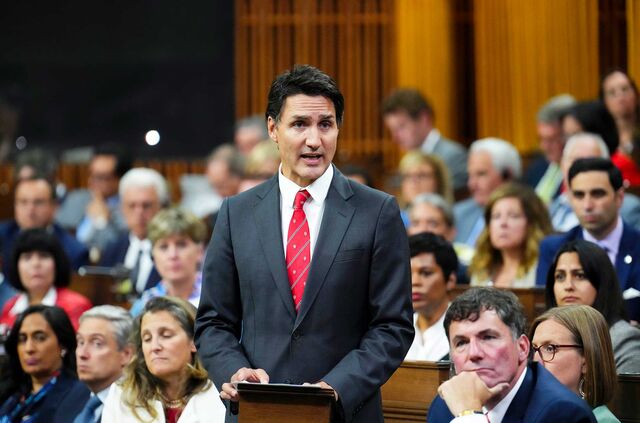 Justin Trudeau speaking at a podium in the House of Commons.