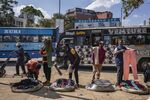 Street vendors sell clothing on a street in Nairobi, Kenya.