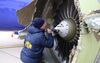 NTSB investigators on scene examining damage to the engine of the Southwest Airlines plane.