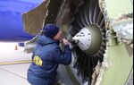 NTSB investigators on scene examining damage to the engine of the Southwest Airlines plane.